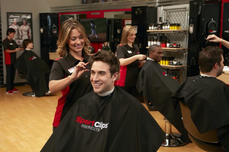a customer and a hairdresser inside a Sports Clip franchise store